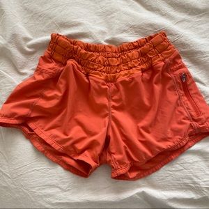 LULU LEMON orange running shorts (size 4)